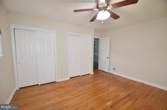 207 Maryland Ave, Newport, DE 19804 - unfurnished bedroom featuring multiple closets, light wood-type flooring, and a ceiling fan