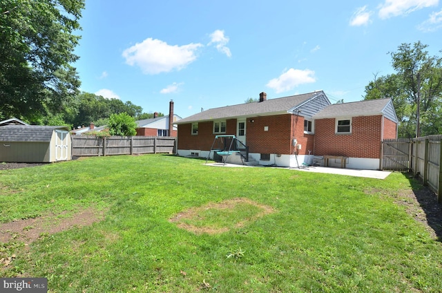 207 Maryland Ave, Newport, DE 19804 - back of property featuring a storage unit, a fenced backyard, a patio area, brick siding, and a chimney