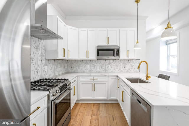 1922 1st St NW Unit B, Washington, DC 20001 - kitchen featuring stainless steel appliances, wall chimney range hood, a peninsula, white cabinetry, and crown molding