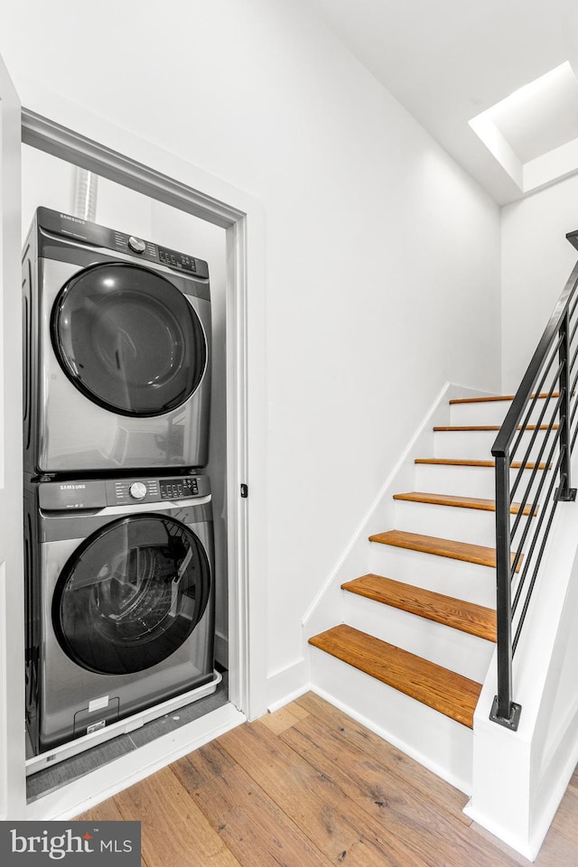 1922 1st St NW Unit B, Washington, DC 20001 - washroom featuring stacked washer / drying machine and wood finished floors