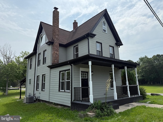 2 Schooner Landing Rd, Millville, NJ 08332 - view of side of home with a porch, a yard, a chimney, and a shingled roof
