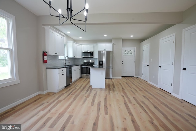 2 Schooner Landing Rd, Millville, NJ 08332 - kitchen featuring appliances with stainless steel finishes, dark countertops, backsplash, white cabinetry, and a chandelier