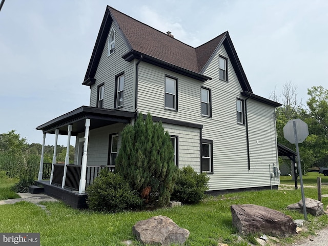 2 Schooner Landing Rd, Millville, NJ 08332 - view of home's exterior featuring a porch, a shingled roof, and a lawn
