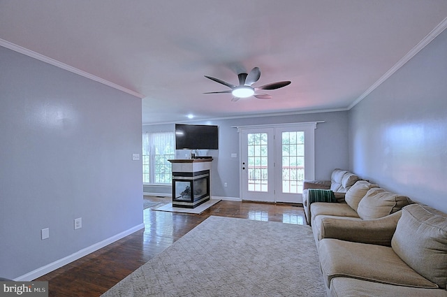 121 Sweetbriar Ln, Winchester, VA 22603 - living room featuring plenty of natural light, ornamental molding, a ceiling fan, dark wood-style flooring, and a tiled fireplace
