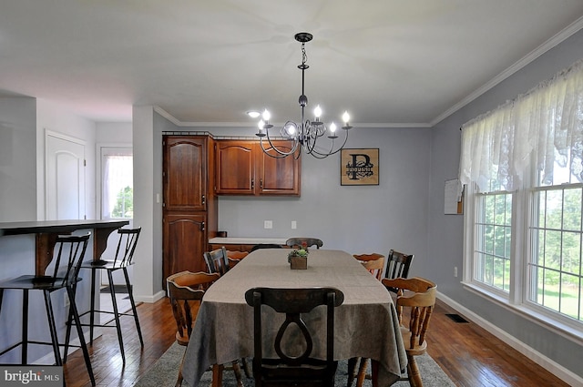 121 Sweetbriar Ln, Winchester, VA 22603 - dining area with plenty of natural light, a chandelier, dark wood-type flooring, and crown molding