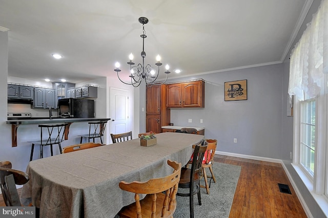 121 Sweetbriar Ln, Winchester, VA 22603 - dining area with a chandelier, dark wood-type flooring, ornamental molding, and recessed lighting