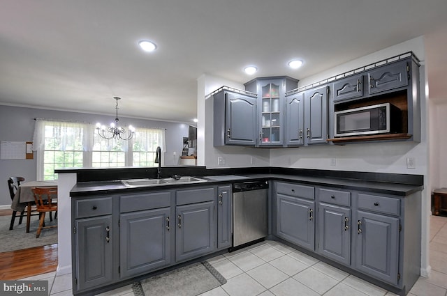 121 Sweetbriar Ln, Winchester, VA 22603 - kitchen featuring stainless steel appliances, dark countertops, gray cabinets, a peninsula, and crown molding