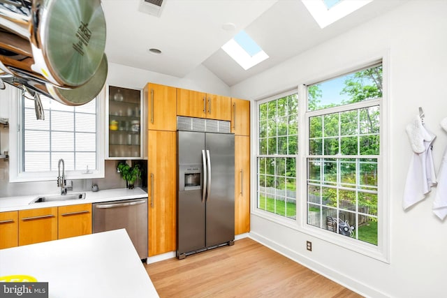 9 Hedgecroft Dr, Pennington, NJ 08534 - kitchen with appliances with stainless steel finishes, a skylight, light countertops, light wood finished floors, and lofted ceiling