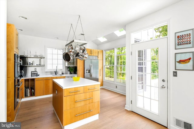 9 Hedgecroft Dr, Pennington, NJ 08534 - kitchen featuring stainless steel appliances, open shelves, a skylight, light wood finished floors, and light countertops