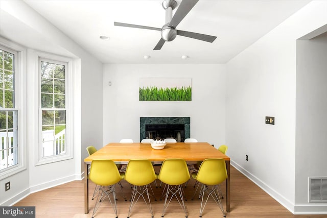 9 Hedgecroft Dr, Pennington, NJ 08534 - dining area with a premium fireplace, light wood-style floors, and ceiling fan