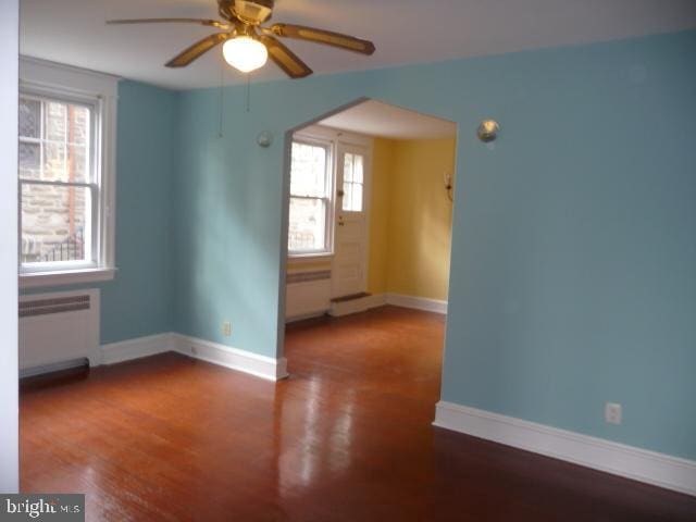 537 E Comly St, Philadelphia, PA 19120 - spare room featuring radiator, a ceiling fan, and wood finished floors