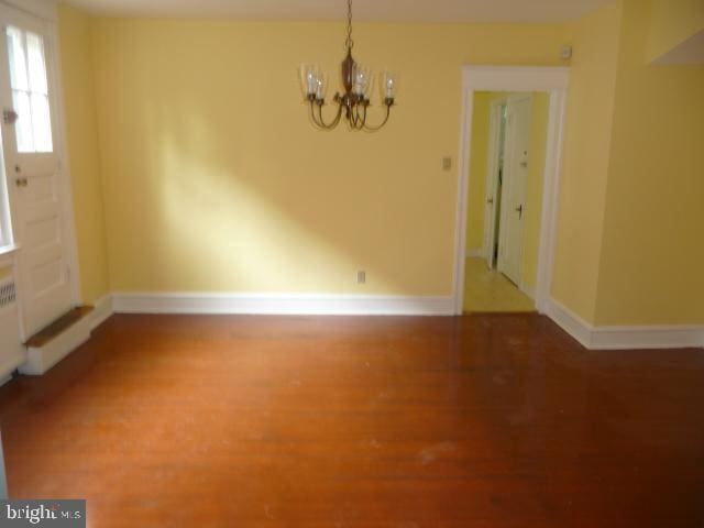 537 E Comly St, Philadelphia, PA 19120 - unfurnished dining area featuring a chandelier and wood finished floors