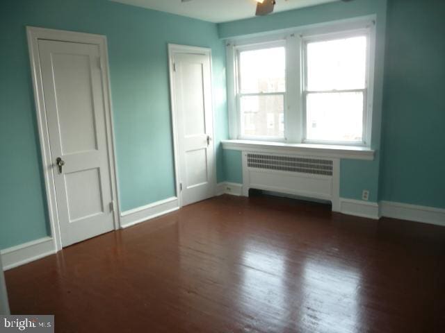 537 E Comly St, Philadelphia, PA 19120 - unfurnished bedroom with radiator and wood finished floors