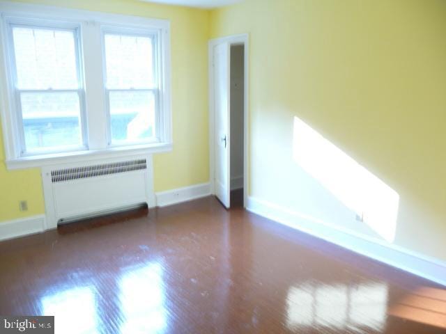 537 E Comly St, Philadelphia, PA 19120 - unfurnished room featuring radiator and wood finished floors