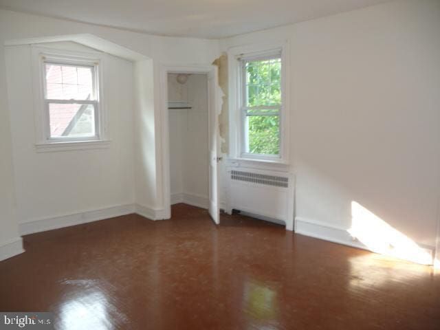537 E Comly St, Philadelphia, PA 19120 - unfurnished bedroom featuring radiator and wood finished floors