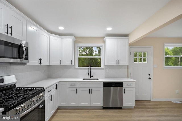 470 E Taunton Ave, West Berlin, NJ 08091 - kitchen featuring appliances with stainless steel finishes, light countertops, decorative backsplash, white cabinetry, and recessed lighting