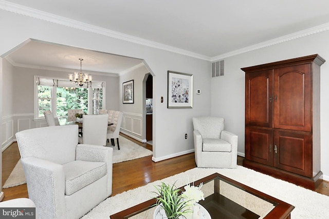 11166 Deuaughn Ct, Fairfax Station, VA 22039 - living room featuring dark wood finished floors, arched walkways, a chandelier, and crown molding