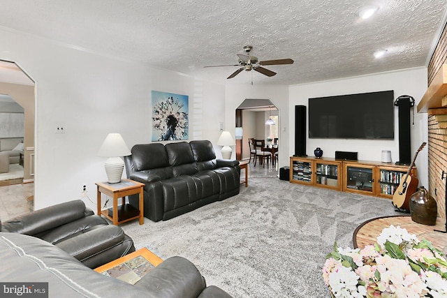 11166 Deuaughn Ct, Fairfax Station, VA 22039 - living room with arched walkways, ceiling fan, a textured ceiling, and carpet flooring