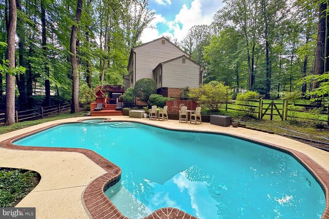 11166 Deuaughn Ct, Fairfax Station, VA 22039 - view of swimming pool featuring a fenced backyard, a patio, and view of wooded area