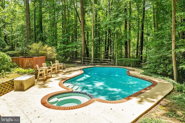 11166 Deuaughn Ct, Fairfax Station, VA 22039 - view of pool featuring a patio, a pool with connected hot tub, and a wooded view