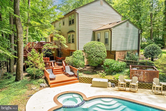 11166 Deuaughn Ct, Fairfax Station, VA 22039 - rear view of property featuring a deck, an in-ground hot tub, a patio, an outdoor pool, and brick siding