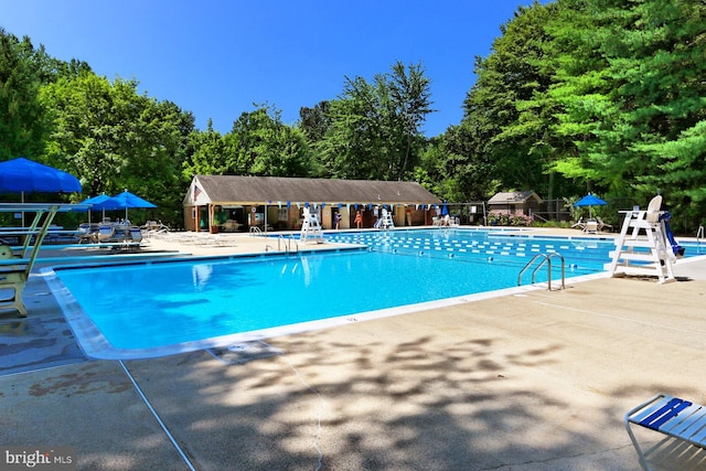 11166 Deuaughn Ct, Fairfax Station, VA 22039 - community pool featuring a patio area and view of wooded area