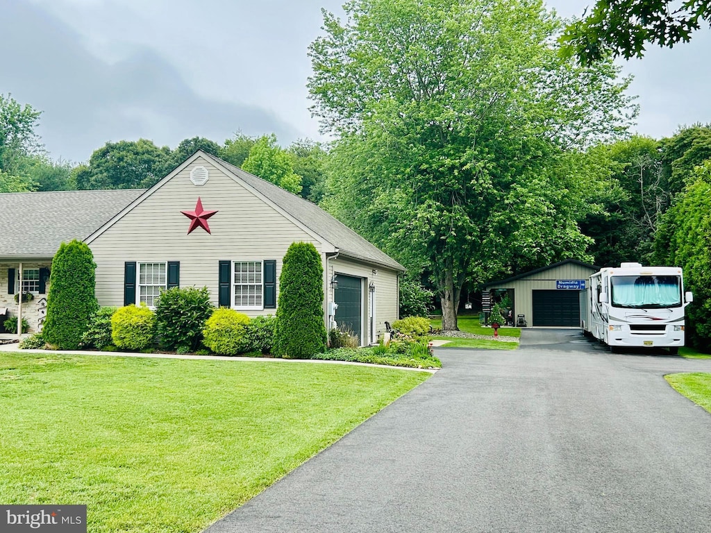 1821 York Ave, Williamstown, NJ 08094 - view of front facade with a detached garage, a front yard, and an outbuilding