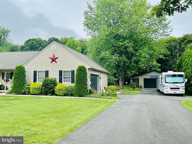 1821 York Ave, Williamstown, NJ 08094 - view of front facade with a detached garage, a front yard, and an outbuilding