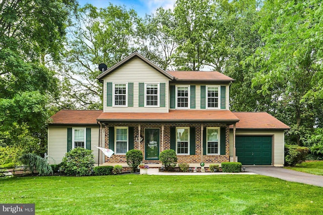 22 Piston Ct, Stewartstown, PA 17363 - view of front of property featuring a garage, driveway, covered porch, and brick siding