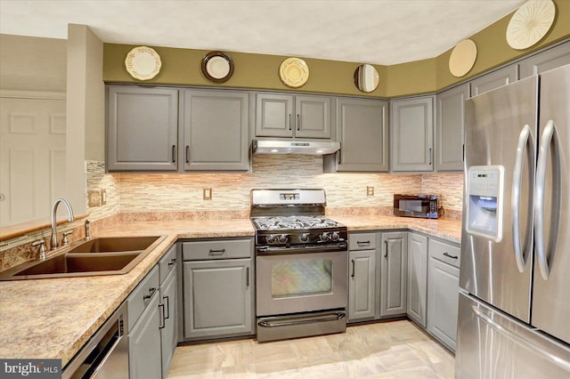 22 Piston Ct, Stewartstown, PA 17363 - kitchen featuring stainless steel appliances, gray cabinetry, under cabinet range hood, and backsplash