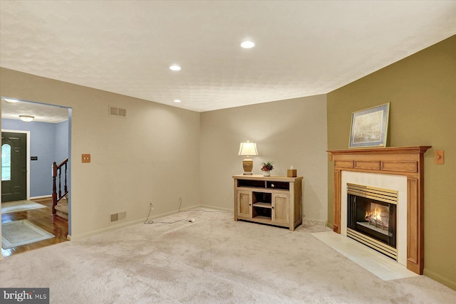 22 Piston Ct, Stewartstown, PA 17363 - unfurnished living room featuring a premium fireplace, light colored carpet, stairs, and recessed lighting