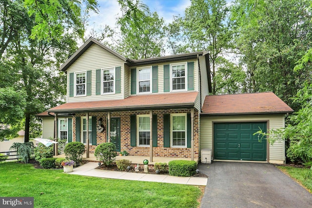 22 Piston Ct, Stewartstown, PA 17363 - view of front facade with an attached garage, a porch, a front yard, driveway, and brick siding