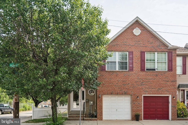2641 E Juniata St, Philadelphia, PA 19137 - view of property featuring driveway, a garage, and brick siding