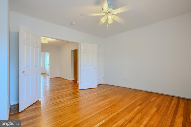 305 Folcroft St, Baltimore, MD 21224 - empty room with light wood finished floors and a ceiling fan