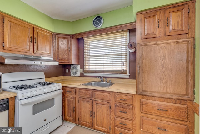 601 King George Rd, Cherry Hill, NJ 08034 - kitchen featuring white gas range oven, under cabinet range hood, light countertops, brown cabinets, and light tile patterned floors