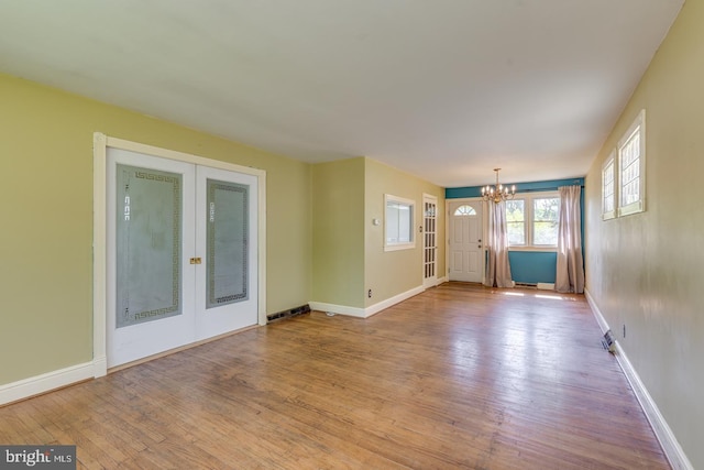 601 King George Rd, Cherry Hill, NJ 08034 - unfurnished living room with a chandelier, wood finished floors, and french doors