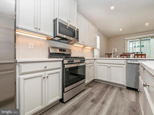 3745 Cedar Mountain Way, Hanover, MD 21076 - kitchen featuring appliances with stainless steel finishes, light countertops, light wood-style floors, recessed lighting, and white cabinets