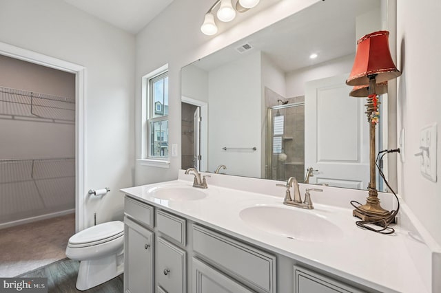 3745 Cedar Mountain Way, Hanover, MD 21076 - bathroom with double vanity, a shower stall, wood finished floors, and a spacious closet