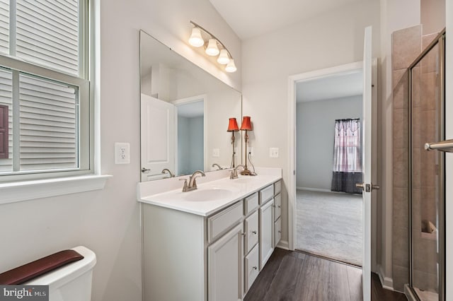 3745 Cedar Mountain Way, Hanover, MD 21076 - bathroom featuring double vanity, wood finished floors, and tiled shower