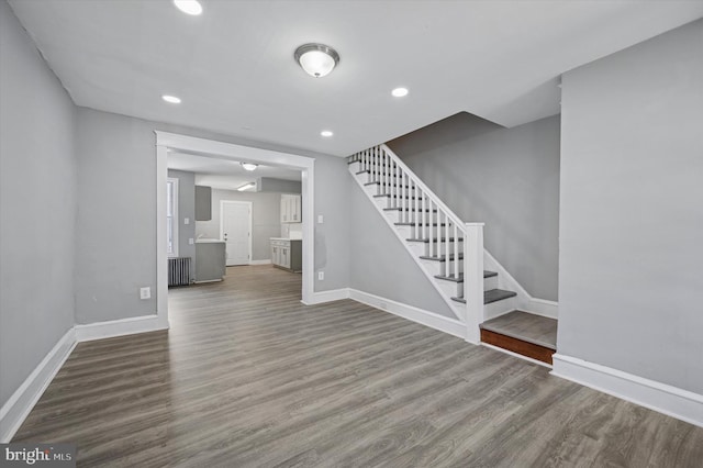510 E Queen Ln, Philadelphia, PA 19144 - unfurnished living room featuring radiator, stairs, wood finished floors, and recessed lighting