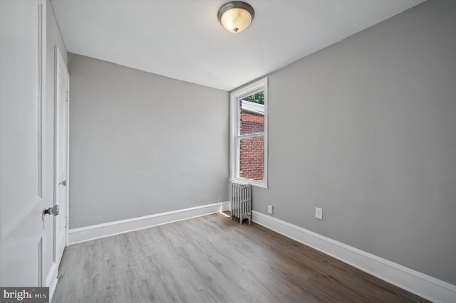 510 E Queen Ln, Philadelphia, PA 19144 - empty room featuring radiator and wood finished floors