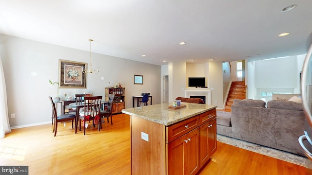 47 Buck Rd, Mays Landing, NJ 08330 - kitchen featuring light wood-type flooring, light stone counters, a kitchen island, open floor plan, and a chandelier