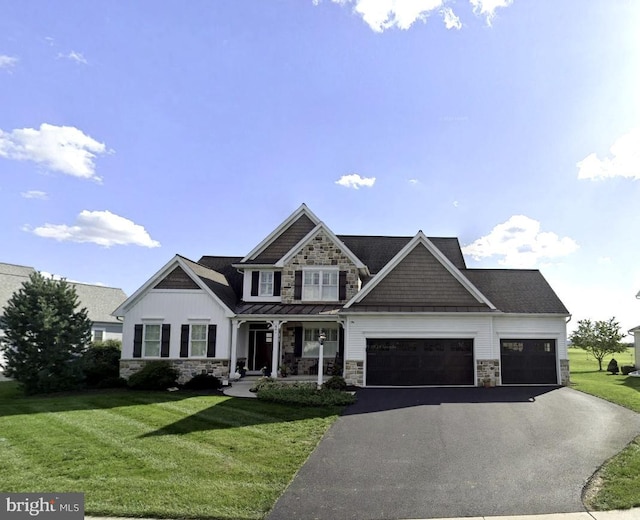 641 Skyler Dr, Mount Joy, PA 17552 - view of front of property with stone siding, a porch, an attached garage, asphalt driveway, and a front yard