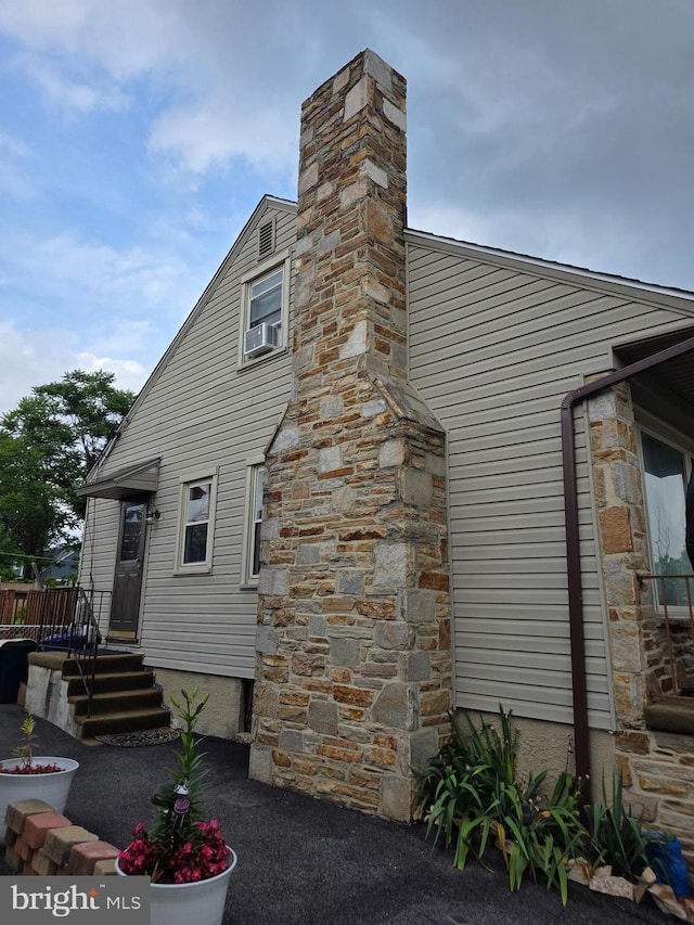 6414 Lehnert St, Baltimore, MD 21207 - view of side of home featuring a chimney and cooling unit