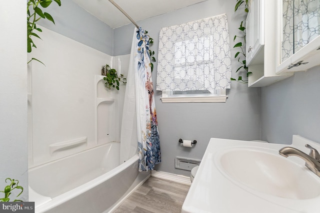5200 Daybreak Ct, Baltimore, MD 21206 - full bathroom featuring shower / bath combination with curtain, wood finished floors, and a baseboard heating unit