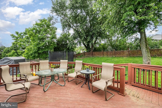 5200 Daybreak Ct, Baltimore, MD 21206 - wooden terrace with a trampoline, a fenced backyard, and a grill