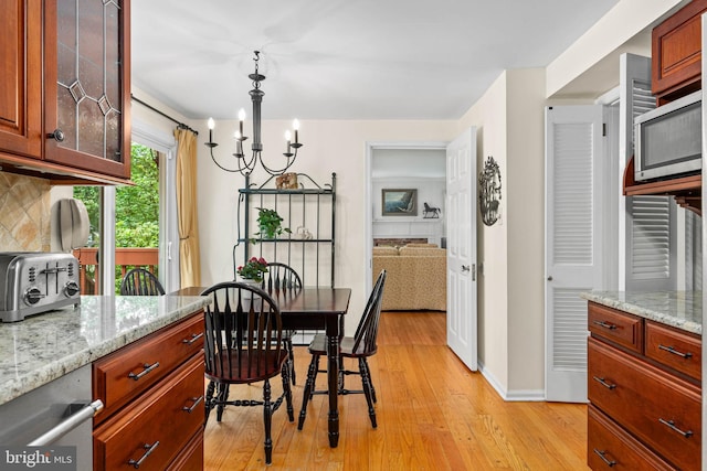 544 N Wayne Ave, Wayne, PA 19087 - dining space featuring light wood finished floors and a chandelier