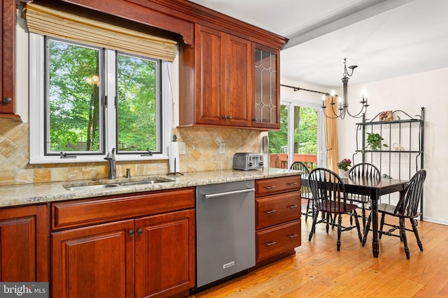 544 N Wayne Ave, Wayne, PA 19087 - kitchen featuring stainless steel dishwasher, backsplash, light wood finished floors, light stone counters, and glass insert cabinets