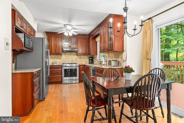 544 N Wayne Ave, Wayne, PA 19087 - kitchen featuring appliances with stainless steel finishes, under cabinet range hood, a ceiling fan, backsplash, and light wood-style flooring