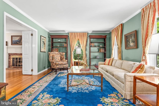 544 N Wayne Ave, Wayne, PA 19087 - living room featuring wood finished floors, crown molding, and a brick fireplace